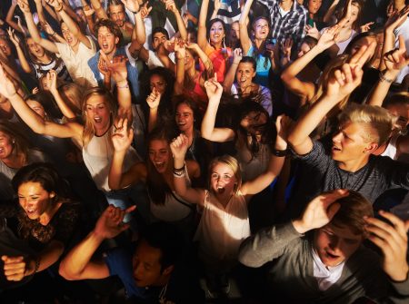 Music, dance and party with crowd at concert for rock, live band performance or festival. New year, energy and disco with audience of fans listening at celebration for techno, rave or nightclub event